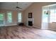 Bright living room with fireplace, hardwood floors, and large windows offering plenty of natural light at 205 Windbyrne Dr, Cary, NC 27513
