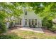 Outdoor patio space features stone pavers, chair seating, and a lush, green backyard at 216 Beringer Pl, Chapel Hill, NC 27516
