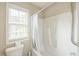 Clean bathroom with a white shower-tub combination and natural light from window at 216 Beringer Pl, Chapel Hill, NC 27516