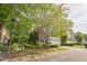 Charming two-story brick home with a two-car garage, lush trees, and manicured shrubs at 216 Beringer Pl, Chapel Hill, NC 27516