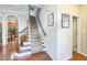 Welcoming foyer with hardwood floors and a staircase leading to the upper level at 216 Beringer Pl, Chapel Hill, NC 27516