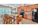 Kitchen with brown cabinets, bar seating, stainless steel appliances, and tile floors at 216 Beringer Pl, Chapel Hill, NC 27516