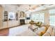 Cozy living room with built-in shelving, a fireplace, and large windows for natural light at 216 Beringer Pl, Chapel Hill, NC 27516