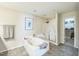 Main bathroom features a soaking tub, walk-in shower, and access to a large walk-in closet at 216 Beringer Pl, Chapel Hill, NC 27516