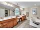 Well-appointed main bathroom featuring dual vanities, soaking tub, and a walk-in shower at 216 Beringer Pl, Chapel Hill, NC 27516
