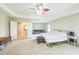 Expansive main bedroom featuring a tray ceiling, ceiling fan, and access to ensuite bath and lounge at 216 Beringer Pl, Chapel Hill, NC 27516