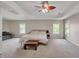 Bright main bedroom featuring a tray ceiling, ceiling fan, and great natural light from multiple windows at 216 Beringer Pl, Chapel Hill, NC 27516