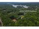 Beautiful aerial view of home located at 249 Rawhide Dr Louisburg surrounded by woods and a lake at 249 Rawhide Dr, Louisburg, NC 27549