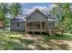 Well-maintained backyard featuring a porch with stairs that create an inviting outdoor space at 249 Rawhide Dr, Louisburg, NC 27549