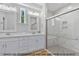 Elegant bathroom with dual vanities, framed mirrors, and a glass-enclosed shower at 249 Rawhide Dr, Louisburg, NC 27549