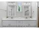 Bright bathroom featuring double sinks with modern fixtures and decorative framed mirrors at 249 Rawhide Dr, Louisburg, NC 27549