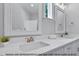 Bathroom featuring double sinks with modern fixtures and decorative framed mirrors at 249 Rawhide Dr, Louisburg, NC 27549