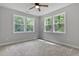 Bright bedroom featuring carpeted floors, gray walls and a ceiling fan at 249 Rawhide Dr, Louisburg, NC 27549