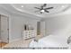 Bright bedroom showcases a decorative tray ceiling and ample natural light for a serene space at 249 Rawhide Dr, Louisburg, NC 27549