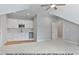 Wet bar in finished bonus room with custom cabinets and stainless steel appliances at 249 Rawhide Dr, Louisburg, NC 27549