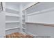 Walk-in closet featuring ample shelving and rod space for optimal storage at 249 Rawhide Dr, Louisburg, NC 27549