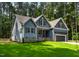 Charming home with blue siding, black shutters, brick foundation and well-manicured green lawn at 249 Rawhide Dr, Louisburg, NC 27549