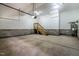 Spacious two-car garage with painted walls and concrete floors, and stairs to a side door at 249 Rawhide Dr, Louisburg, NC 27549