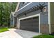 A beautiful two car garage attached to the house with a concrete driveway at 249 Rawhide Dr, Louisburg, NC 27549