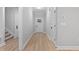 Bright hallway with wood floors, white trim and walls, and multiple doorways at 249 Rawhide Dr, Louisburg, NC 27549