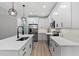 Modern kitchen featuring white cabinetry, stainless steel appliances, and a sleek design at 249 Rawhide Dr, Louisburg, NC 27549