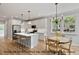 Modern kitchen with stainless steel appliances, a center island, and an adjacent dining area at 249 Rawhide Dr, Louisburg, NC 27549