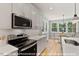 Well-equipped kitchen with stainless steel appliances, ample counter space, and a view to the dining area at 249 Rawhide Dr, Louisburg, NC 27549
