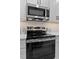 Modern kitchen features stainless steel appliances, white cabinetry, and sleek countertops at 249 Rawhide Dr, Louisburg, NC 27549