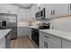 Modern kitchen with white cabinets, stainless steel appliances, and elegant countertops at 249 Rawhide Dr, Louisburg, NC 27549