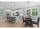 Open kitchen with stainless steel appliances, white cabinetry, and a connected dining area at 249 Rawhide Dr, Louisburg, NC 27549