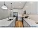 Modern kitchen featuring a large island, stainless steel appliances, and sleek countertops at 249 Rawhide Dr, Louisburg, NC 27549