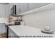 Bright kitchen featuring sleek white countertops, modern appliances, and stylish patterned backsplash at 249 Rawhide Dr, Louisburg, NC 27549