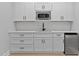 Modern kitchenette with white cabinets, stainless steel appliances, and sleek countertops at 249 Rawhide Dr, Louisburg, NC 27549