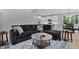 Cozy living room with a comfortable sectional sofa, stylish rug, and open view to the kitchen at 249 Rawhide Dr, Louisburg, NC 27549