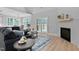 Comfortable living room with fireplace, plush seating, and access to an outdoor deck at 249 Rawhide Dr, Louisburg, NC 27549