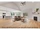 Bright, open living room with fireplace, hardwood floors, and seamless flow to the kitchen at 249 Rawhide Dr, Louisburg, NC 27549