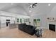 Open-concept living room featuring a modern kitchen, fireplace, and sliding glass doors to the outdoors at 249 Rawhide Dr, Louisburg, NC 27549