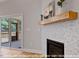 Living room with a tiled fireplace and a sliding glass door leading to the outdoor deck at 249 Rawhide Dr, Louisburg, NC 27549