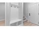 Bright mudroom features a bench, storage cubbies, coat hooks, and wood-look flooring at 249 Rawhide Dr, Louisburg, NC 27549