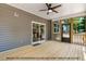 Relaxing screened-in porch with ceiling fan and wooden flooring provides seamless indoor-outdoor living at 249 Rawhide Dr, Louisburg, NC 27549