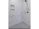 Shower features gray mosaic tile flooring and a built-in niche for storage at 249 Rawhide Dr, Louisburg, NC 27549