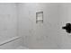 Shower with white marble-look tile, bench seating and a built-in shower niche at 249 Rawhide Dr, Louisburg, NC 27549