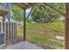 View of the backyard from under the deck with partial privacy fence and wooded area at 2705 Wyntercrest Ln, Durham, NC 27713