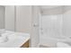 Bathroom features a shower-tub combo with a white showerhead and faucet and wood vanity at 2705 Wyntercrest Ln, Durham, NC 27713