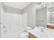 Clean bathroom features a shower-tub combo, white tile, and wooden vanity at 2705 Wyntercrest Ln, Durham, NC 27713