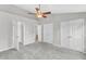 Spacious bedroom features plush carpet, ceiling fan, and multiple closets for ample storage at 2705 Wyntercrest Ln, Durham, NC 27713