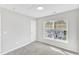 Cozy bedroom with neutral carpet and window, offering a serene space at 2705 Wyntercrest Ln, Durham, NC 27713