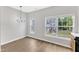 Bright dining room with modern light fixture and large windows at 2705 Wyntercrest Ln, Durham, NC 27713