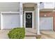 Charming townhome entrance with black door, garage and welcoming wreath at 2705 Wyntercrest Ln, Durham, NC 27713