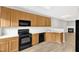 Open kitchen features wooden cabinets and views into the living room at 2705 Wyntercrest Ln, Durham, NC 27713